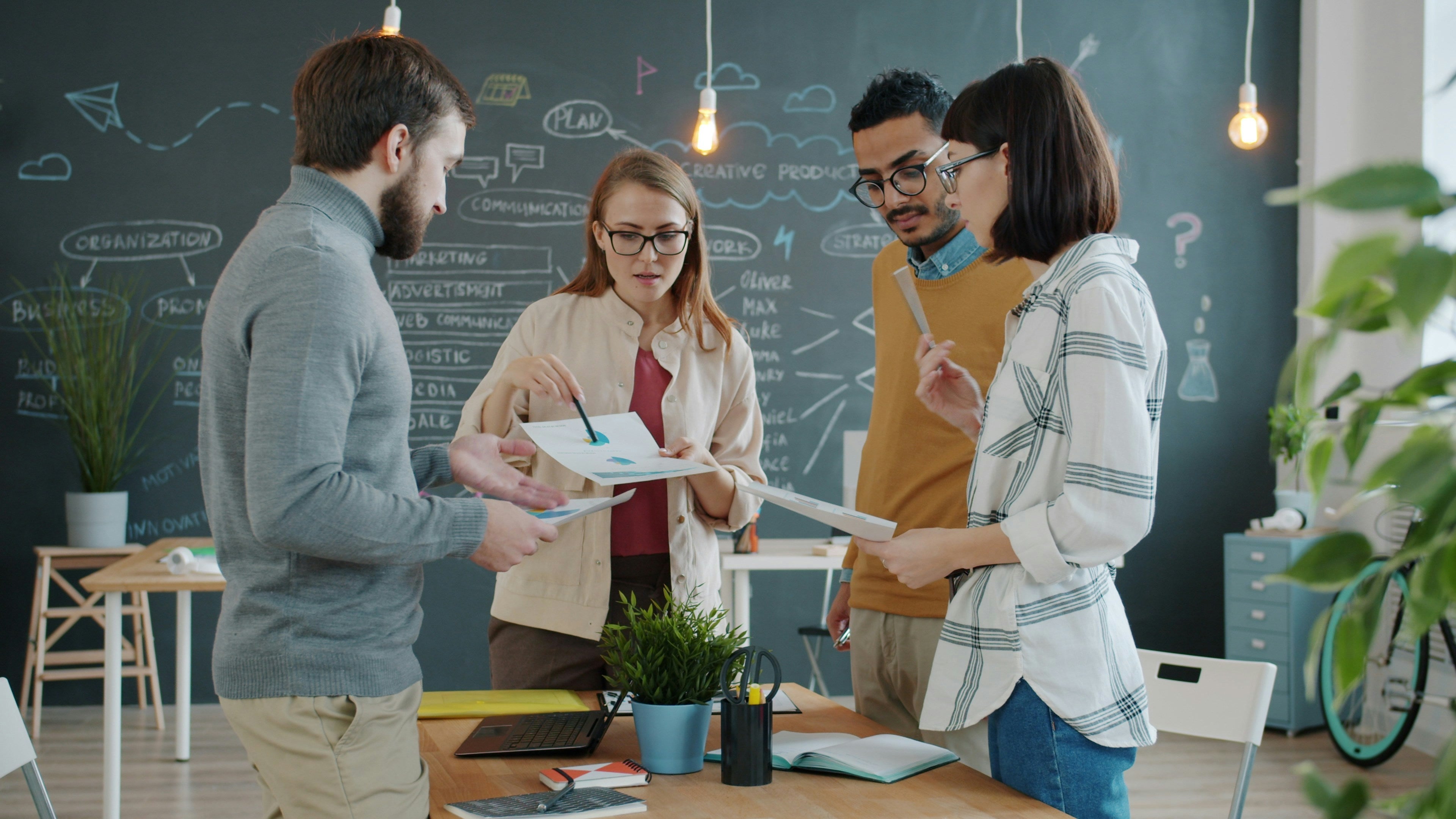 Team brainstorming session supporting why redesigns should be triggered by business change