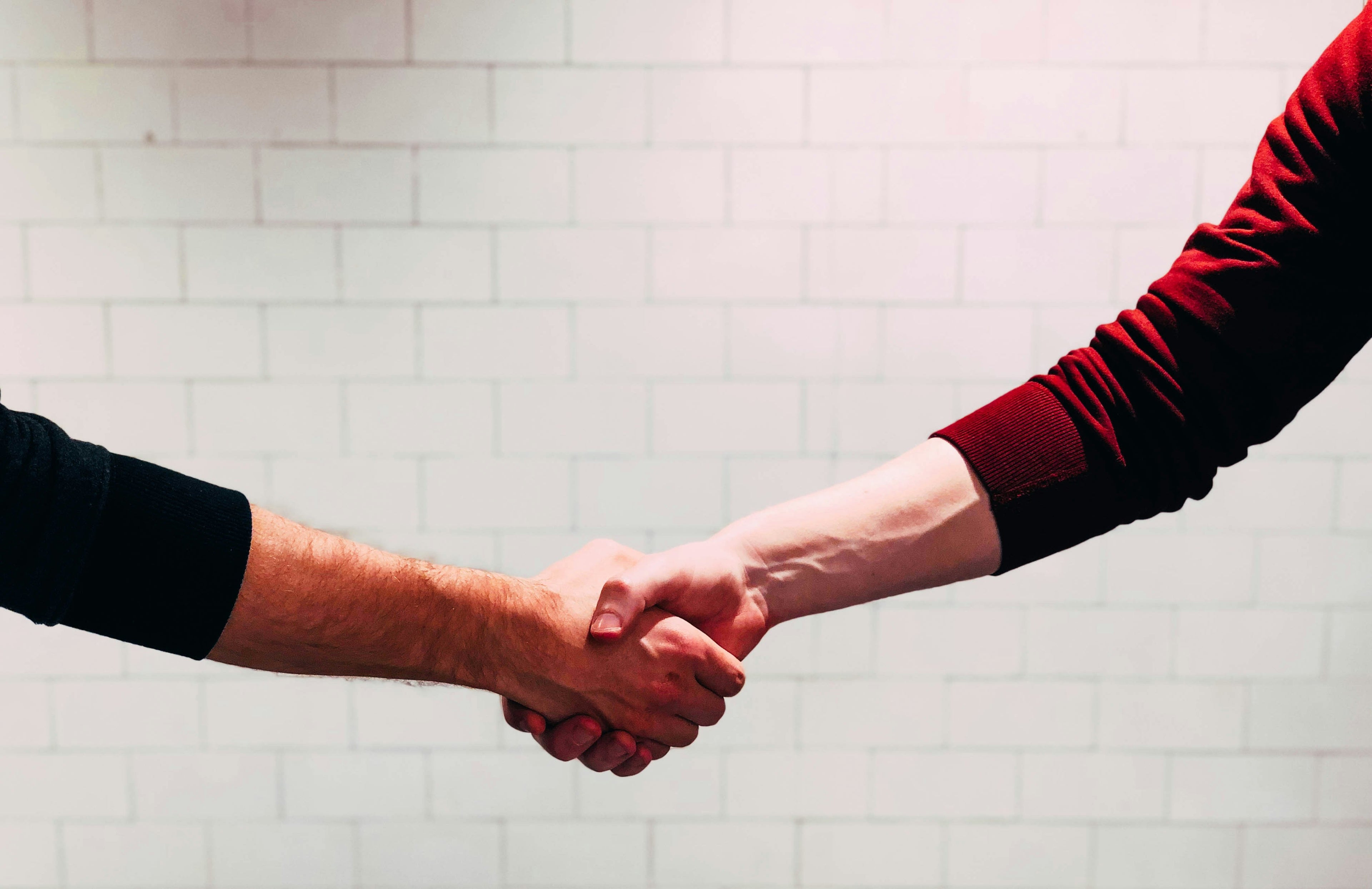 Handshake agreement moment supporting why cheaper Shopify builds cost more over time