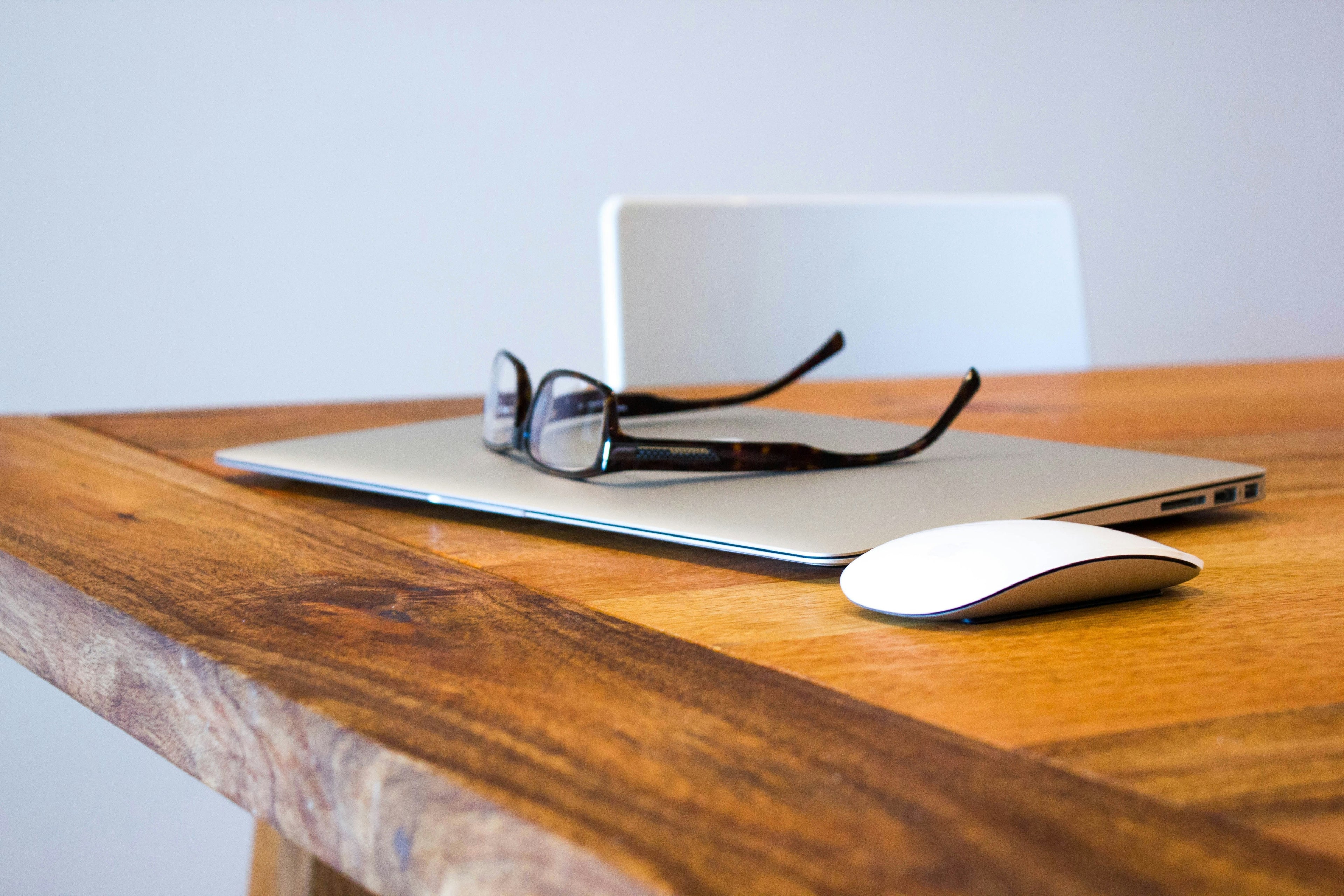 Minimal workspace with laptop and glasses supporting why too many options hurt Shopify conversions