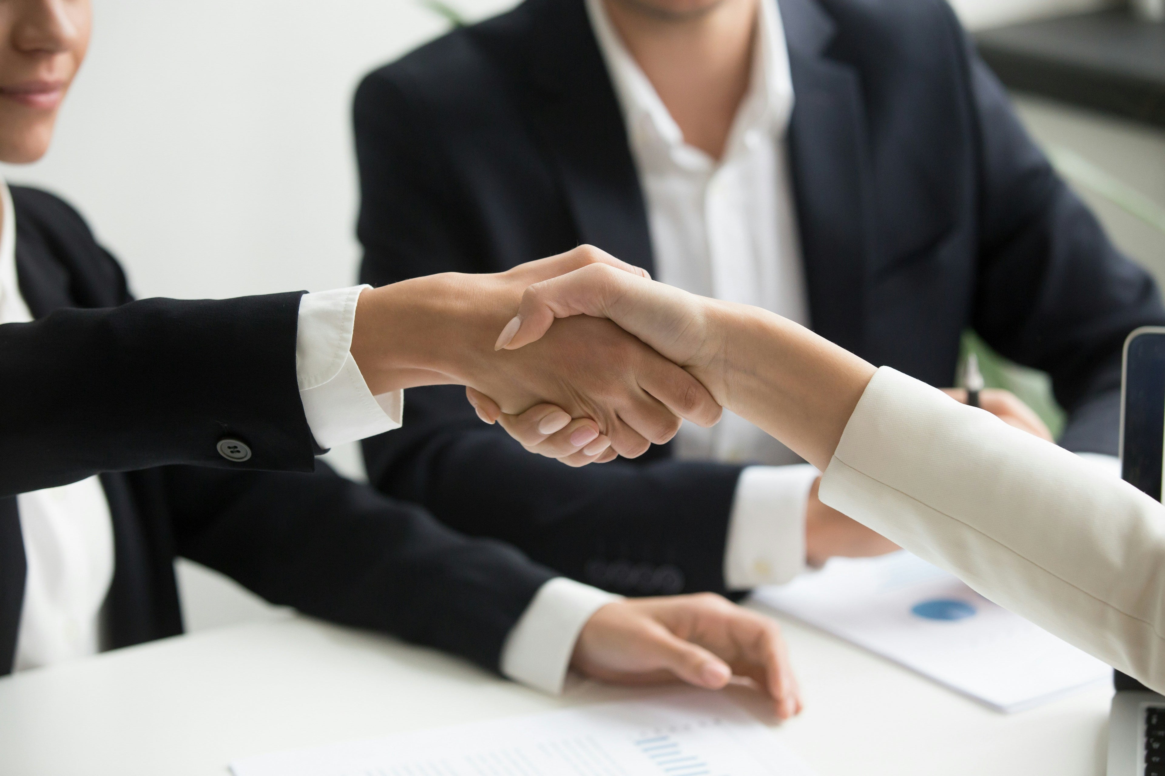 Partnership handshake agreement supporting what store owners get wrong about Shopify B2B