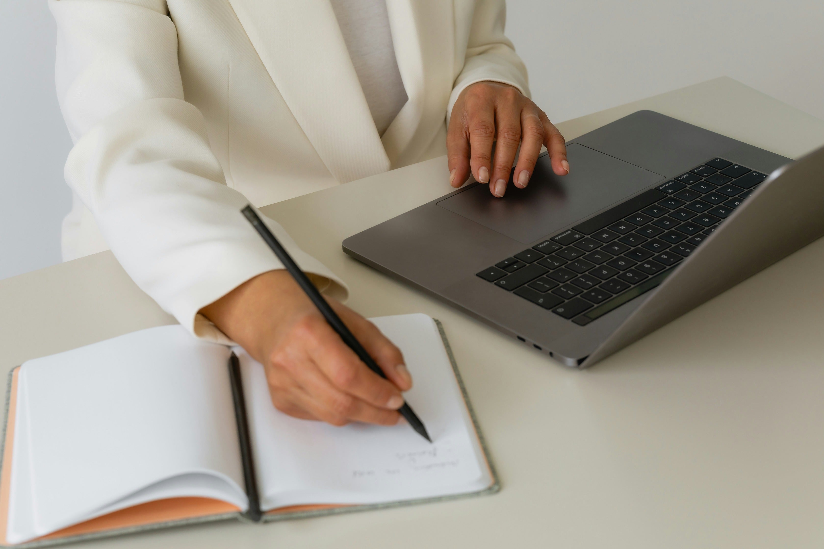 Planning notes and laptop supporting content structure work during Shopify migrations