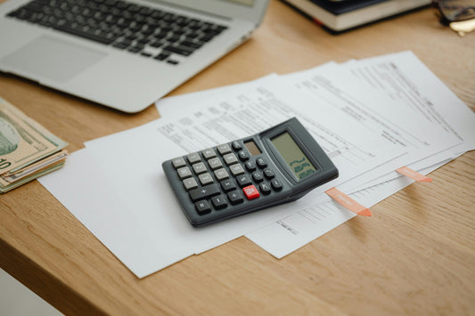 Budgeting and cost planning on a desk supporting Shopify pricing by outcomes not hours